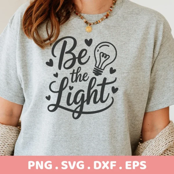 Be the Light SVG" design on gray shirt, a digital cut file for Cricut and Silhouette projects.
