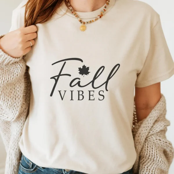 Woman wearing t-shirt with "Fall Vibes" design, a digital SVG for DIY crafts.