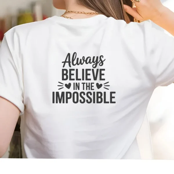 White t-shirt with "Believe Impossible" SVG design, a digital file for crafting.