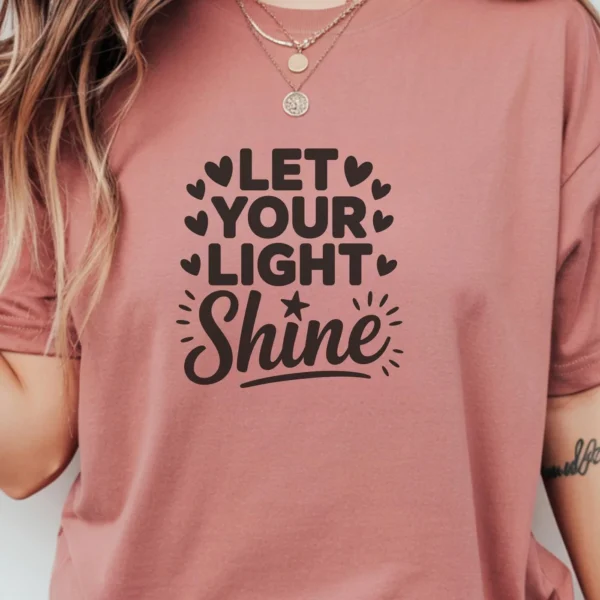 Let Shine" SVG design on a mauve t-shirt, a digital file for Cricut and Silhouette crafting.